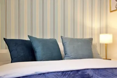 a bedroom with a bed with blue pillows at \u30aa\u30fc\u30d6\u30ea\u30aa\u30f3\u6075\u6bd4\u5bff201 in Tokyo