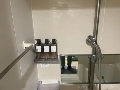 a row of bottles of wine on a glass shelf at Green Apple Otsuka 201 in JR Otsuka station in Tokyo