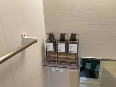 two bottles of alcohol sitting on a shelf in a door at Green Apple Otsuka 201 in JR Otsuka station in Tokyo