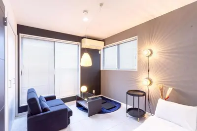 a living room with a blue couch and some windows at 30 sec to Station,4min to Skytree,82sqm,Sleeps 8,Free Parking,Close to Akihabara Asakusa Ueno in Tokyo