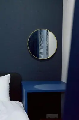 a mirror on a wall above a bed with a blue table at 30 sec to Station,4min to Skytree,82sqm,Sleeps 8,Free Parking,Close to Akihabara Asakusa Ueno in Tokyo