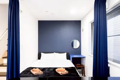 a bedroom with a bed and a blue wall at 30 sec to Station,4min to Skytree,82sqm,Sleeps 8,Free Parking,Close to Akihabara Asakusa Ueno in Tokyo