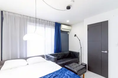a bedroom with a bed and a black leather chair at 30 sec to Station,4min to Skytree,82sqm,Sleeps 8,Free Parking,Close to Akihabara Asakusa Ueno in Tokyo