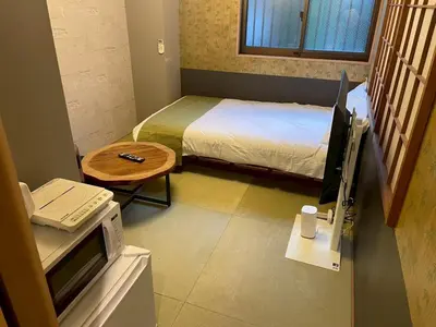 a small room with a bed and a desk with a computer at Asakusa Retreat Designer curated stylish room 1 in Tokyo