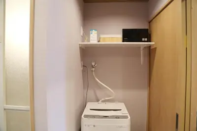 a small bathroom with a washing machine and a shelf at M207 Easy access to Ikebukuro Red Leaves ,Golden Ginkgo in Tokyo