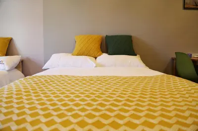 a bedroom with a large bed with yellow and green sheets at M207 Easy access to Ikebukuro Red Leaves ,Golden Ginkgo in Tokyo