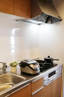 a kitchen with a stove with two pans on it at M207 Easy access to Ikebukuro Red Leaves ,Golden Ginkgo in Tokyo