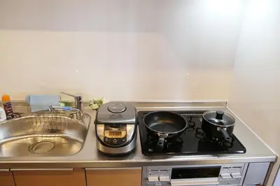 a stove with two pots on it next to a sink at M207 Easy access to Ikebukuro Red Leaves ,Golden Ginkgo in Tokyo