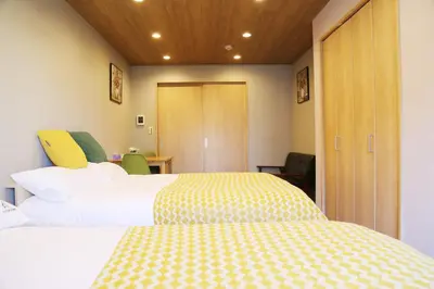 a hotel room with two beds and a closet at M207 Easy access to Ikebukuro Red Leaves ,Golden Ginkgo in Tokyo