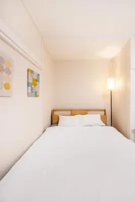 a white bedroom with a large white bed at 7 min to JR Otsuka,Direct Yamanote Line ,1 stop to Ikebukuro,Direct to Shinjuku ,Shibuya,Fully Renovated,18 sqm,2 Guests #101 in Tokyo