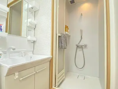 a white bathroom with a shower and a sink at SK - Tokyo Ikebukuro Premium Comfort 4LDK Entire house in Tokyo