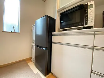 a kitchen with a microwave and a refrigerator at SK - Tokyo Ikebukuro Premium Comfort 4LDK Entire house in Tokyo