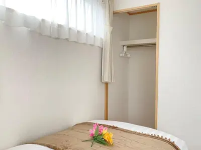 a room with a bed with flowers on it at SK - Tokyo Ikebukuro Premium Comfort 4LDK Entire house in Tokyo