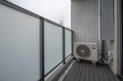 a balcony with a fan on the side of a building at \u30eb\u30cd\u30b5\u30f3\u30b9\u30b3\u30fc\u30c8\u672c\u6240\u543e\u59bb\u6a4b in Tokyo