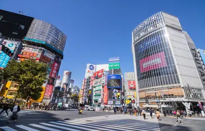 a busy city street with people crossing a crosswalk at \u30b3\u30f3\u30c6\u30eb\u897f\u4e94\u53cd\u7530303 in Tokyo
