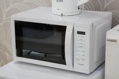 a white microwave oven sitting on top of a counter at \u738b\u5b50\u795e\u8c37\u5e73\u5c4b in Tokyo