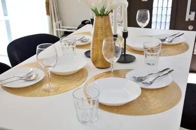 a table with white plates and glasses on it at \u738b\u5b50\u795e\u8c37\u5e73\u5c4b in Tokyo
