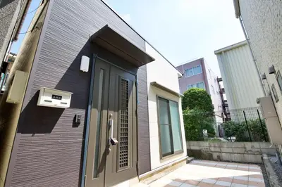 a building with a door and a window on it at \u738b\u5b50\u795e\u8c37\u5e73\u5c4b in Tokyo