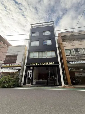 a building with a hotel singiosynrity on a street at Silvership Hotel 101 in Tokyo
