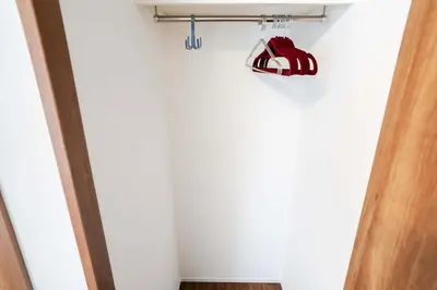 a closet with a red shoe hanging on a wall at New 2025, whole house, 2min Ikebukuro, 5min Shinjuku, 6pax in Tokyo