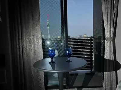 two blue glasses on a table in a room with a window at ROLES Ryusen 902 near Asakusa,Ueno,Skytree in Tokyo