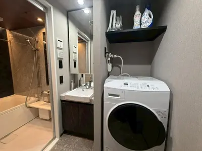 a washing machine in a bathroom with a sink at ROLES Ryusen 902 near Asakusa,Ueno,Skytree in Tokyo