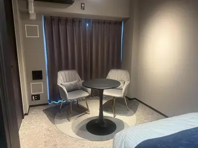 a room with a table and two chairs and a bed at ROLES Ryusen 902 near Asakusa,Ueno,Skytree in Tokyo