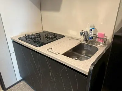 a kitchen counter with a stove and a sink at ROLES Ryusen 902 near Asakusa,Ueno,Skytree in Tokyo