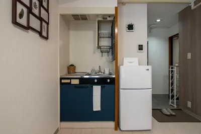 a kitchen with a refrigerator and a sink at CraftFlat Numabukuro 307, uphill residence in Tokyo