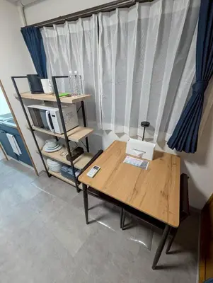 a room with a wooden table and a window at CraftFlat Numabukuro 307, uphill residence in Tokyo