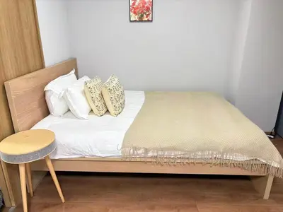 a bed with white sheets and pillows and a table at \u9e1f\u8d8a201\u6210\u7530\u7fbd\u7530\u673a\u573a\u53ef\u76f4\u8fbe\u4ea4\u901a\u4fbf\u5229\u5e02\u4e2d\u5fc3 in Tokyo