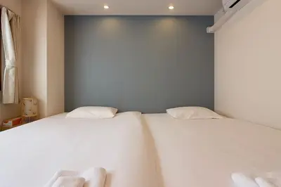 two beds sitting next to each other in a bedroom at Silvership Hotel 501 in Tokyo