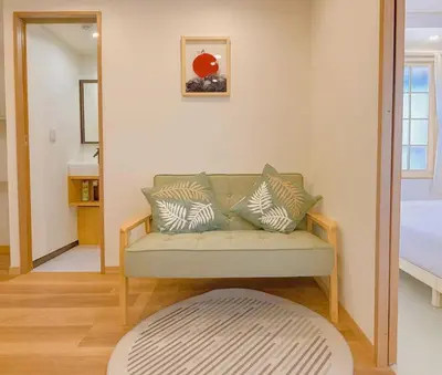a living room with a couch and a bed at Silvership Hotel 501 in Tokyo