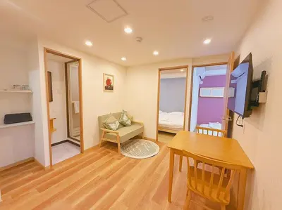 a room with a desk and a table and a room with a bed at Silvership Hotel 501 in Tokyo