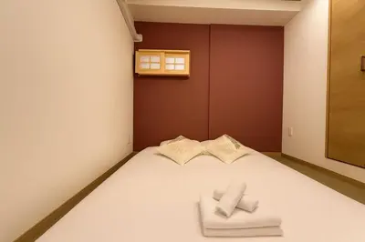 a bedroom with a bed with two towels on it at Silvership Hotel 501 in Tokyo