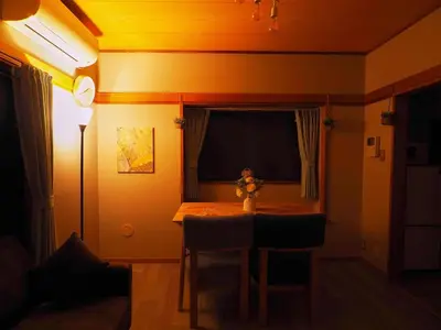 a room with a table with chairs and a window at Haku Nest Ichinoe in Tokyo