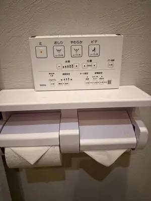 a white towel dispenser sitting on top of a shelf at Silvership Hotel 401 in Tokyo