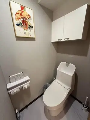 a bathroom with a toilet and a picture on the wall at Silvership Hotel 401 in Tokyo