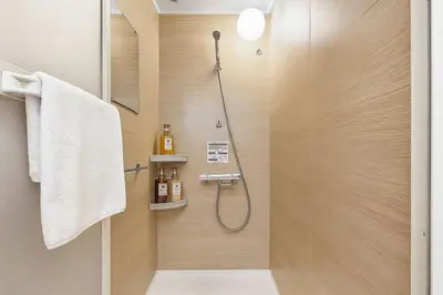 a bathroom with a shower with a glass door at Silvership Hotel 401 in Tokyo