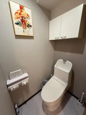 a small bathroom with a white toilet and a painting at Silvership Hotel 402 in Tokyo