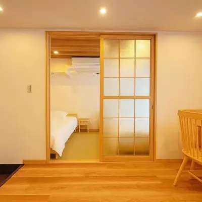 a bedroom with a bed and a sliding glass door at Silvership Hotel 202 in Tokyo
