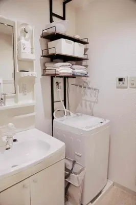 a bathroom with a sink and a washing machine at 501Room,Elevator to the 5th Floor Two Bedroom Apartment Near Tokyo Tower with Direct Train Access to Haneda Narita Airports and Asakusa in Tokyo