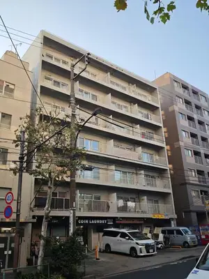 a large building with cars parked in front of it at 501Room,Elevator to the 5th Floor Two Bedroom Apartment Near Tokyo Tower with Direct Train Access to Haneda Narita Airports and Asakusa in Tokyo