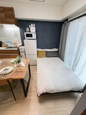 a small room with a bed and a table at Moto Sakura 403,2 bedrooms with 4 beds, 6 people, direct access to Narita and Haneda Airports, Asakusa and Ueno area, 5 train lines available, Bicycles free rental in Tokyo