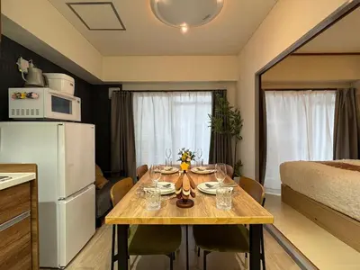 a small kitchen with a table in a room at Moto Sakura 403,2 bedrooms with 4 beds, 6 people, direct access to Narita and Haneda Airports, Asakusa and Ueno area, 5 train lines available, Bicycles free rental in Tokyo