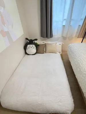 a bed with a stuffed cow sitting on top of it at Moto Sakura 403,2 bedrooms with 4 beds, 6 people, direct access to Narita and Haneda Airports, Asakusa and Ueno area, 5 train lines available, Bicycles free rental in Tokyo