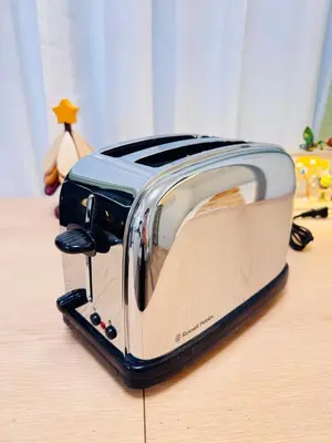 a toaster sitting on top of a wooden table at Moto Sakura 403,2 bedrooms with 4 beds, 6 people, direct access to Narita and Haneda Airports, Asakusa and Ueno area, 5 train lines available, Bicycles free rental in Tokyo