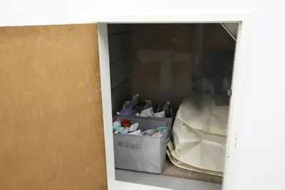 an open door of a room with a container of items at Shinbashi Oliver in Tokyo