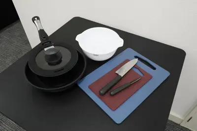 a black table with a lamp and a knife at Shinbashi Oliver in Tokyo