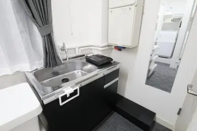 a small kitchen with a sink and a refrigerator at Shinbashi Oliver in Tokyo